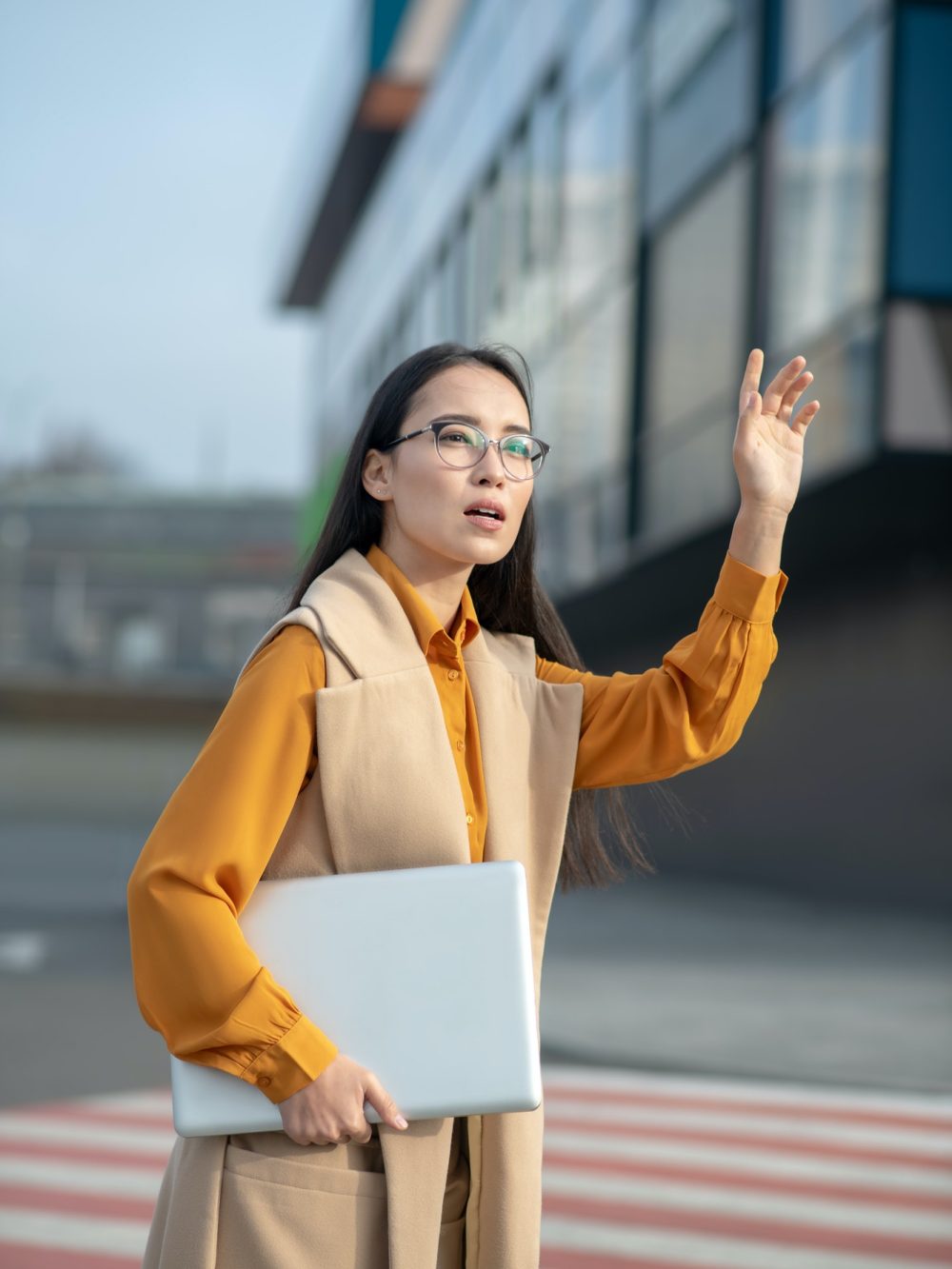 young-asian-pretty-woman-waving-her-hand-on-the-road.jpg